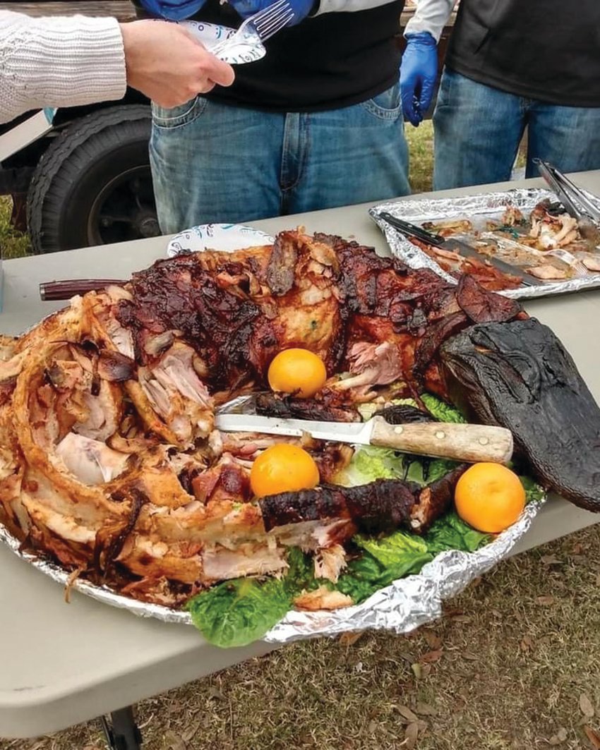 A whole alligator, brined and barbecued, sits ready for the judges to taste at the inaugural Gator Fest.